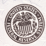 Seal of the United States Federal Reserve System, featuring an eagle atop a shield, surrounded by laurel leaves.